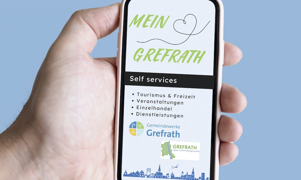 Smartphone in der Hand mit Blick auf den Bildschirm mit der neuen Grefrath-App